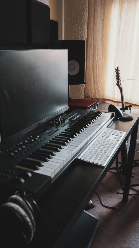 a desk with music equipment and guitar are shown