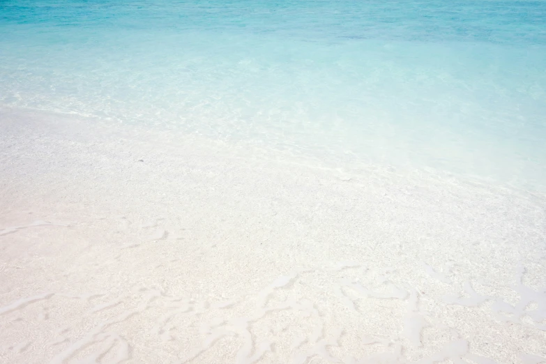 the water is a deep blue and the white sand is clean