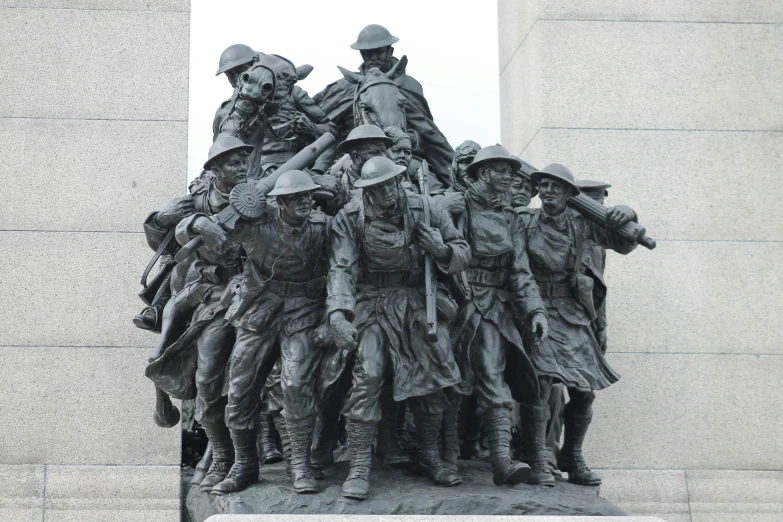 the sculpture has soldiers holding their heads together