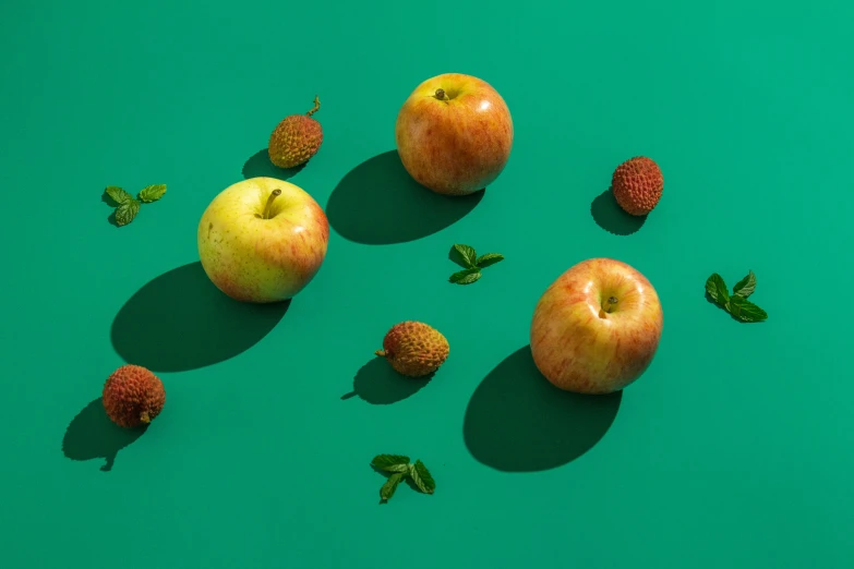 apples and berries on a green background with leaves