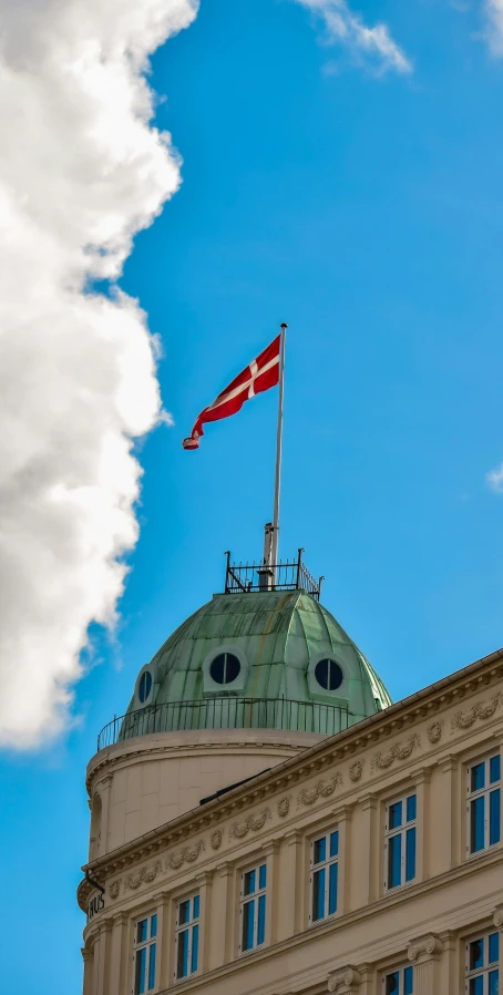 an old building with a flag flying from top