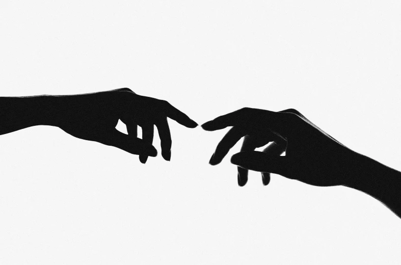 a couple of people with hands reaching for each other