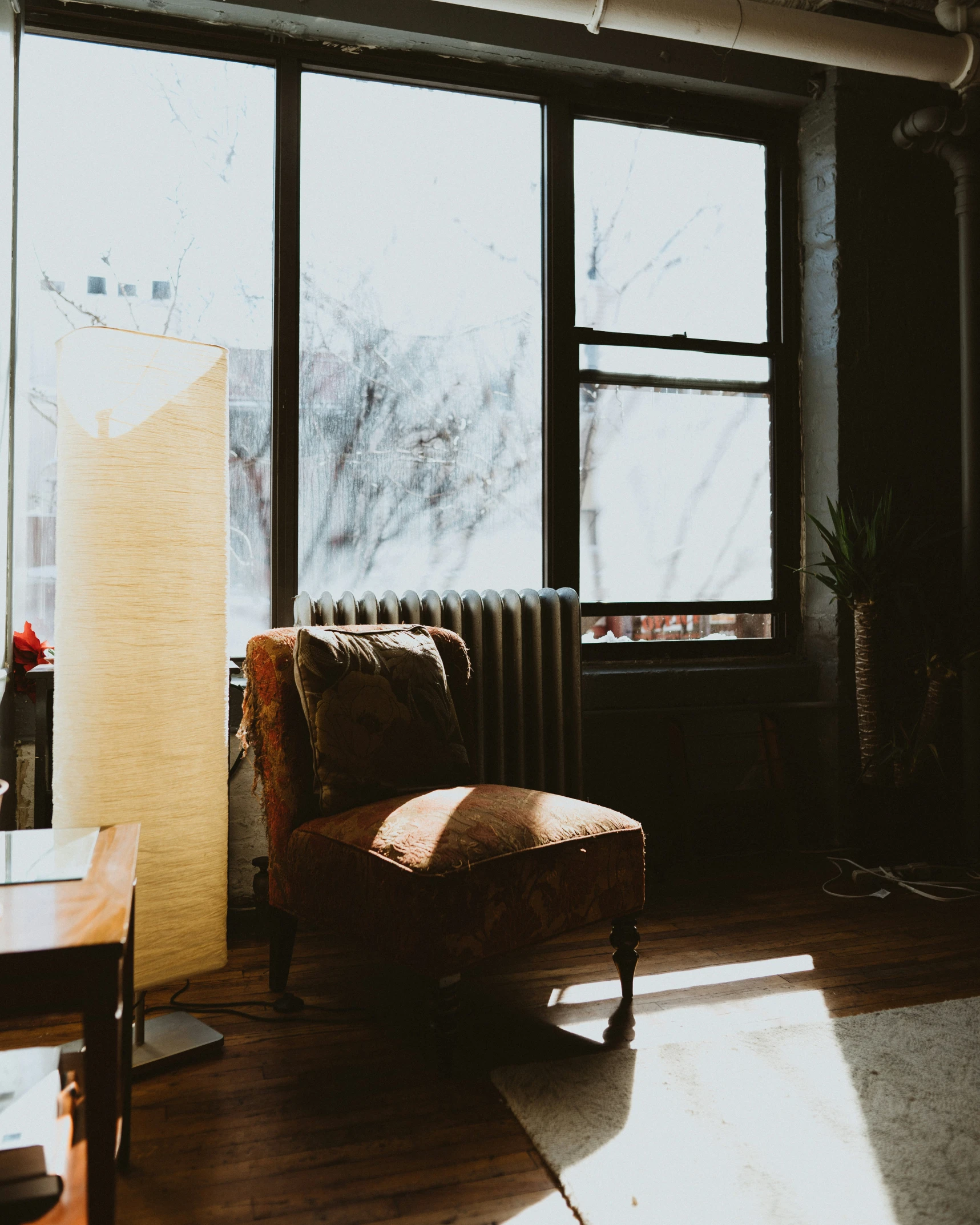 the sun shines brightly through a large window in an empty room