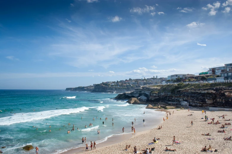 many people are in the water on the beach