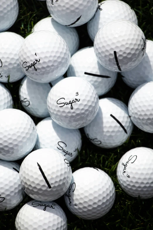 a close up of a number of golf balls on the ground