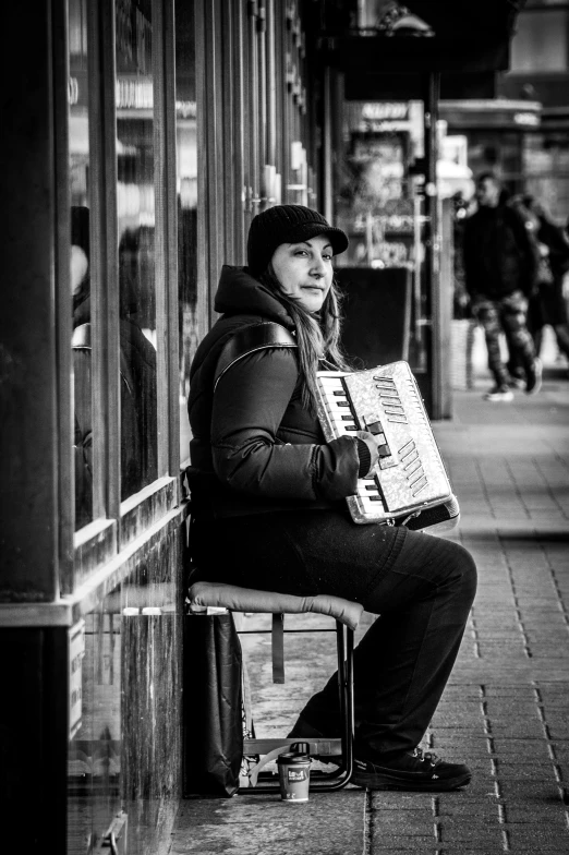 a person sitting on a bench with an accordion