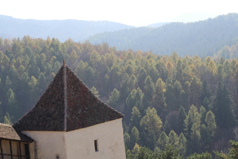 an old white building stands out on a hill