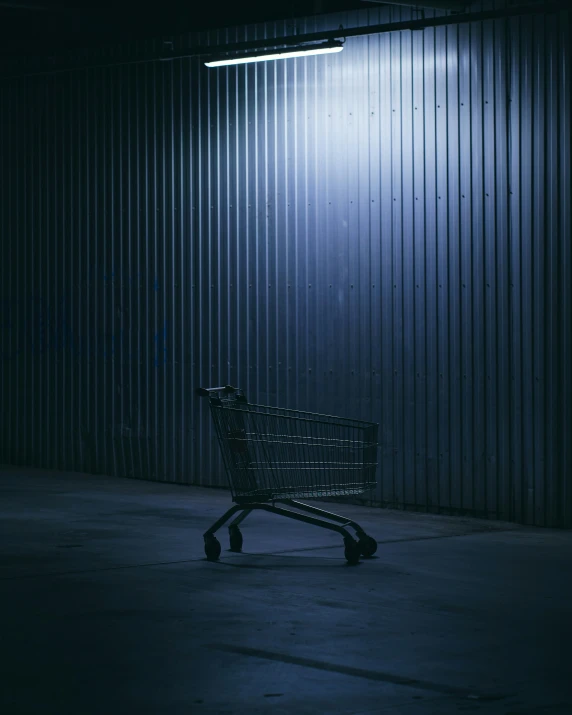 a empty shopping cart outside at night time