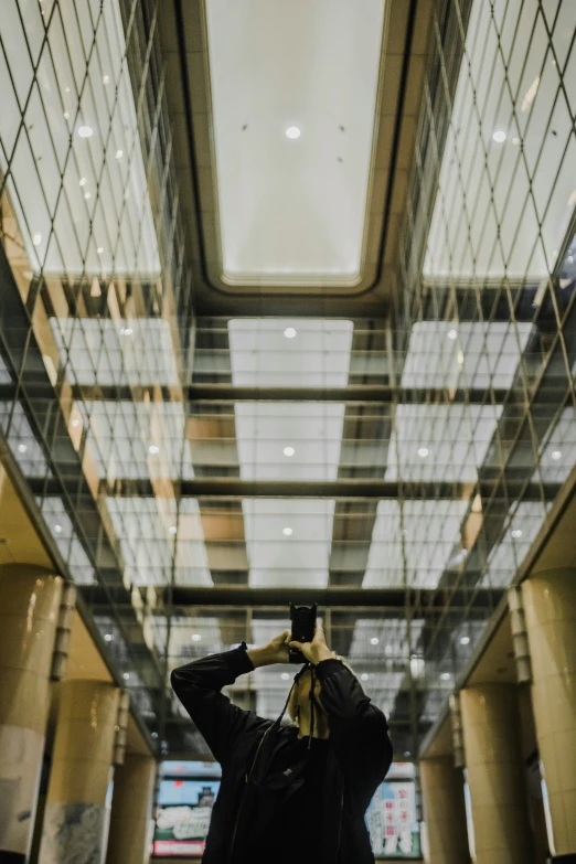 a woman taking pictures of a building and the ceiling