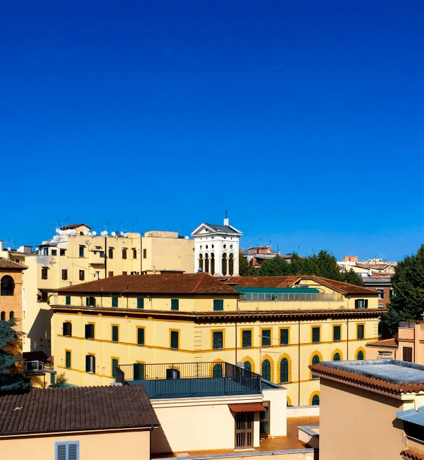 a city scene from a rooftop with an older building in the background