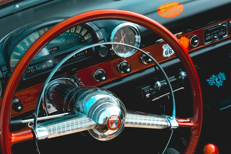 an antique car dashboard with steering wheel, gauge and dash board