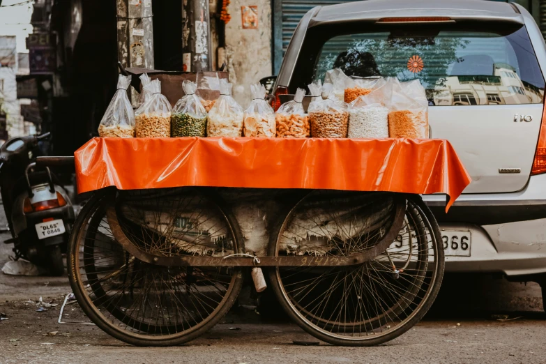 an orange table cloth on top of a bicycle