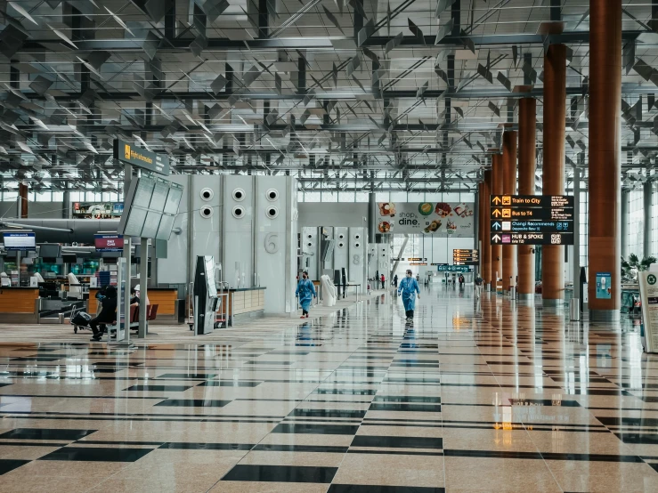 a airport with people walking around on the sidewalks