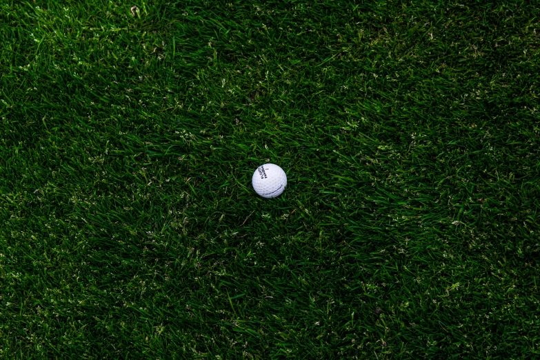 a golf ball on some green grass