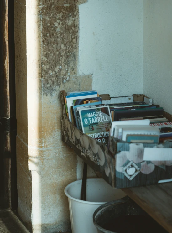 a wall with a bucket and magazine racks