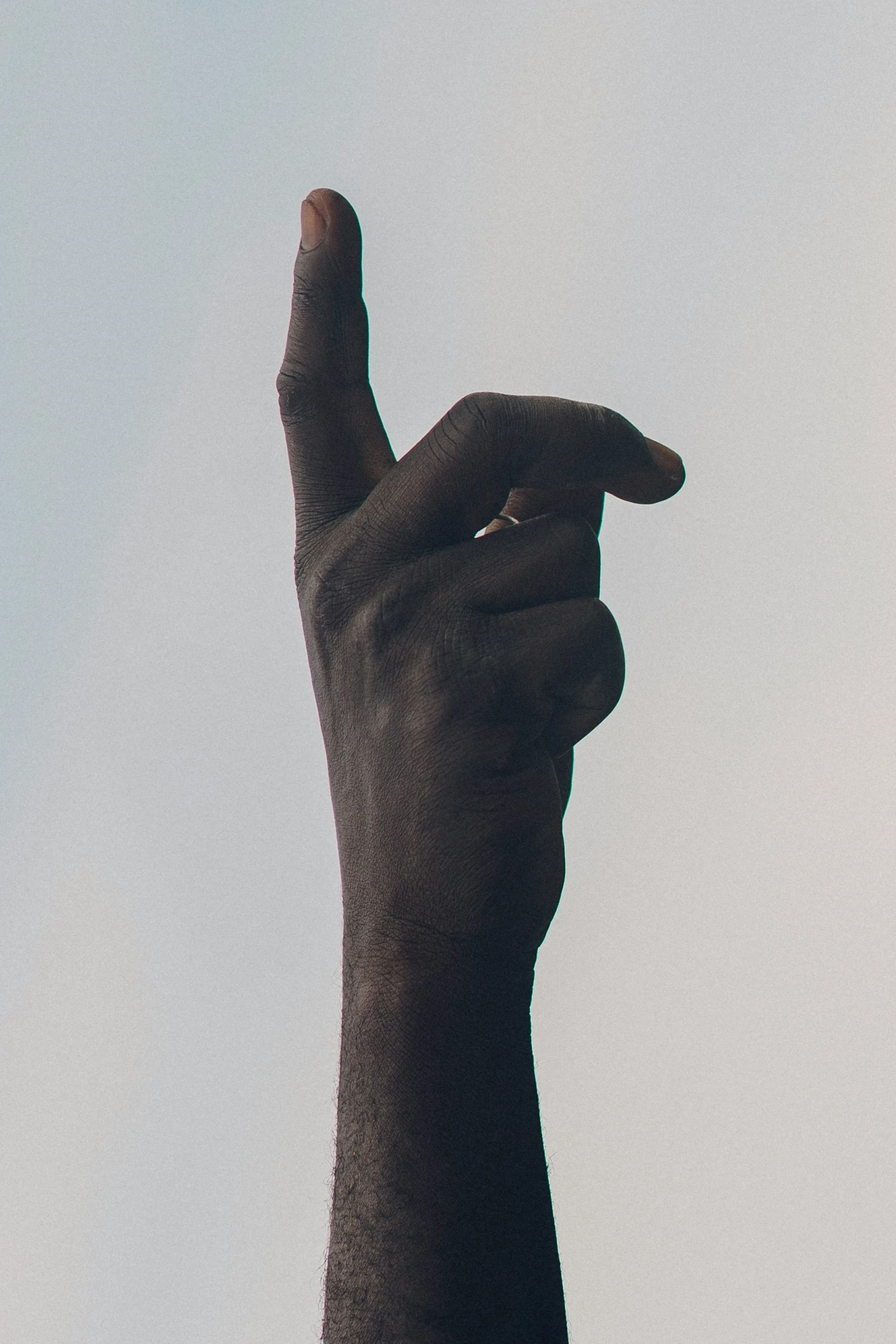 a person's hand holds the tip of a cell phone