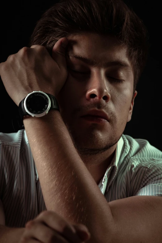 a man in a white shirt is holding his head