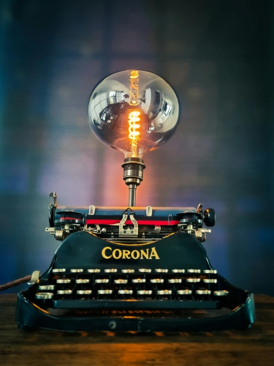 a light bulb is lit over an old typewriter