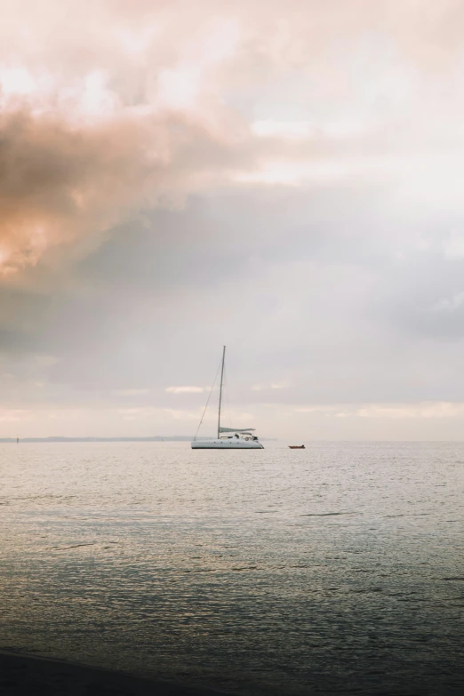 the boat is anchored at the shoreline under a sky