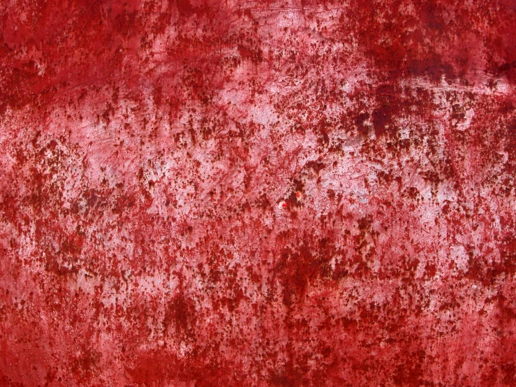 red wall with a lot of paint and peeling on it