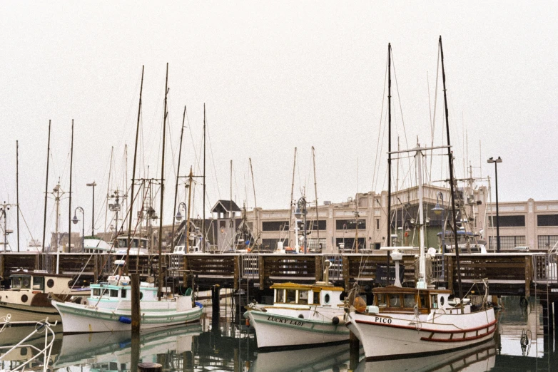 several small boats are tied to the docks