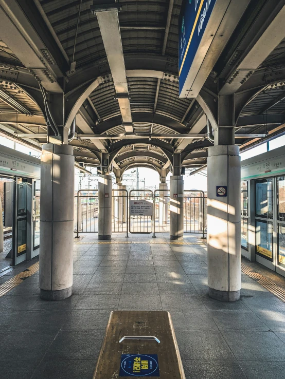 a train station with a bench that is on the floor