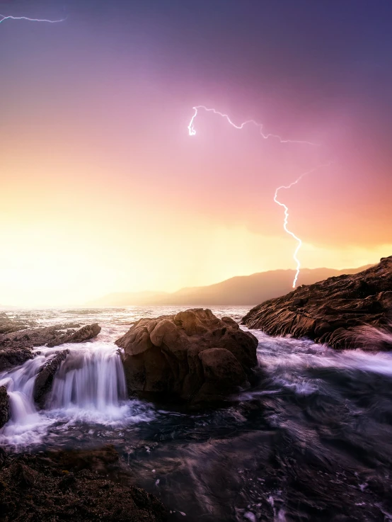 a thunder strike above a waterfall at sunset