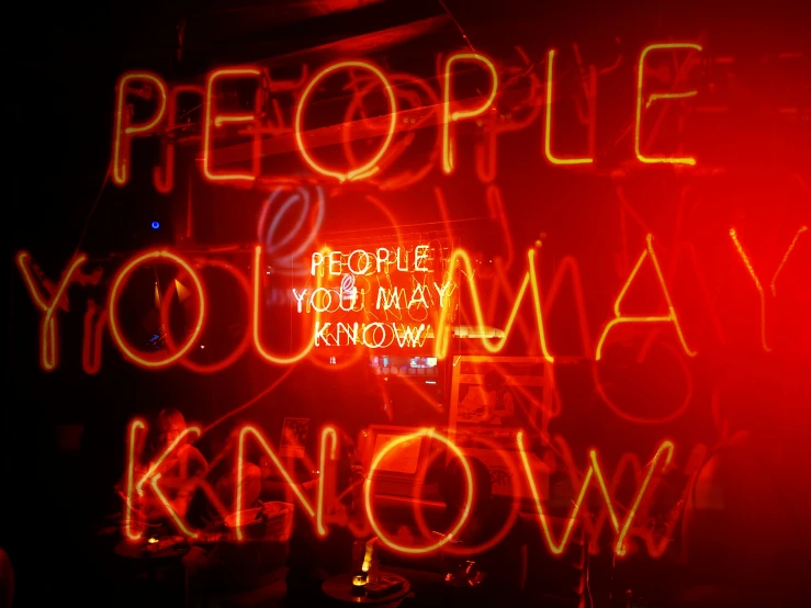 a neon sign over an ipod saying people you may know