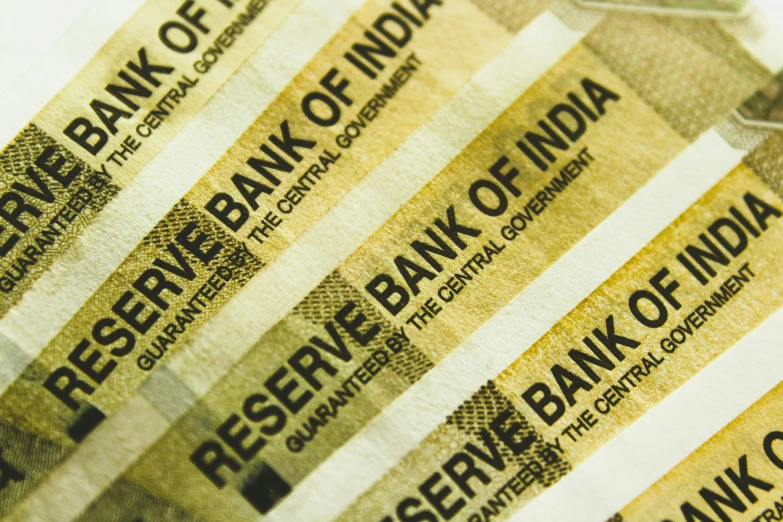 a stack of bank of india notes in color