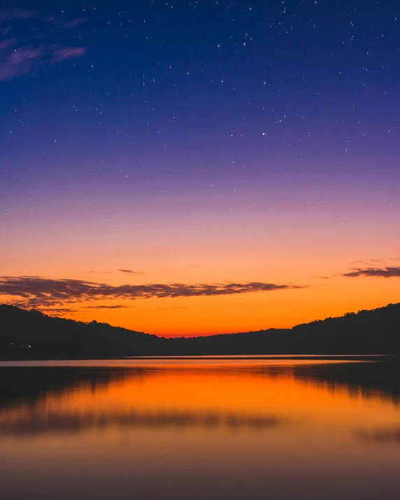 the night sky is reflected in the water