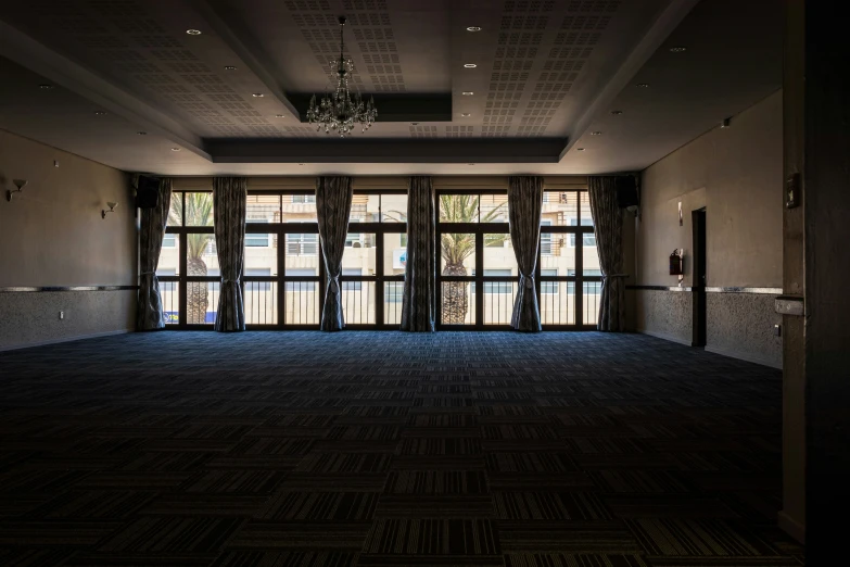 an empty room with open door, and chandelier