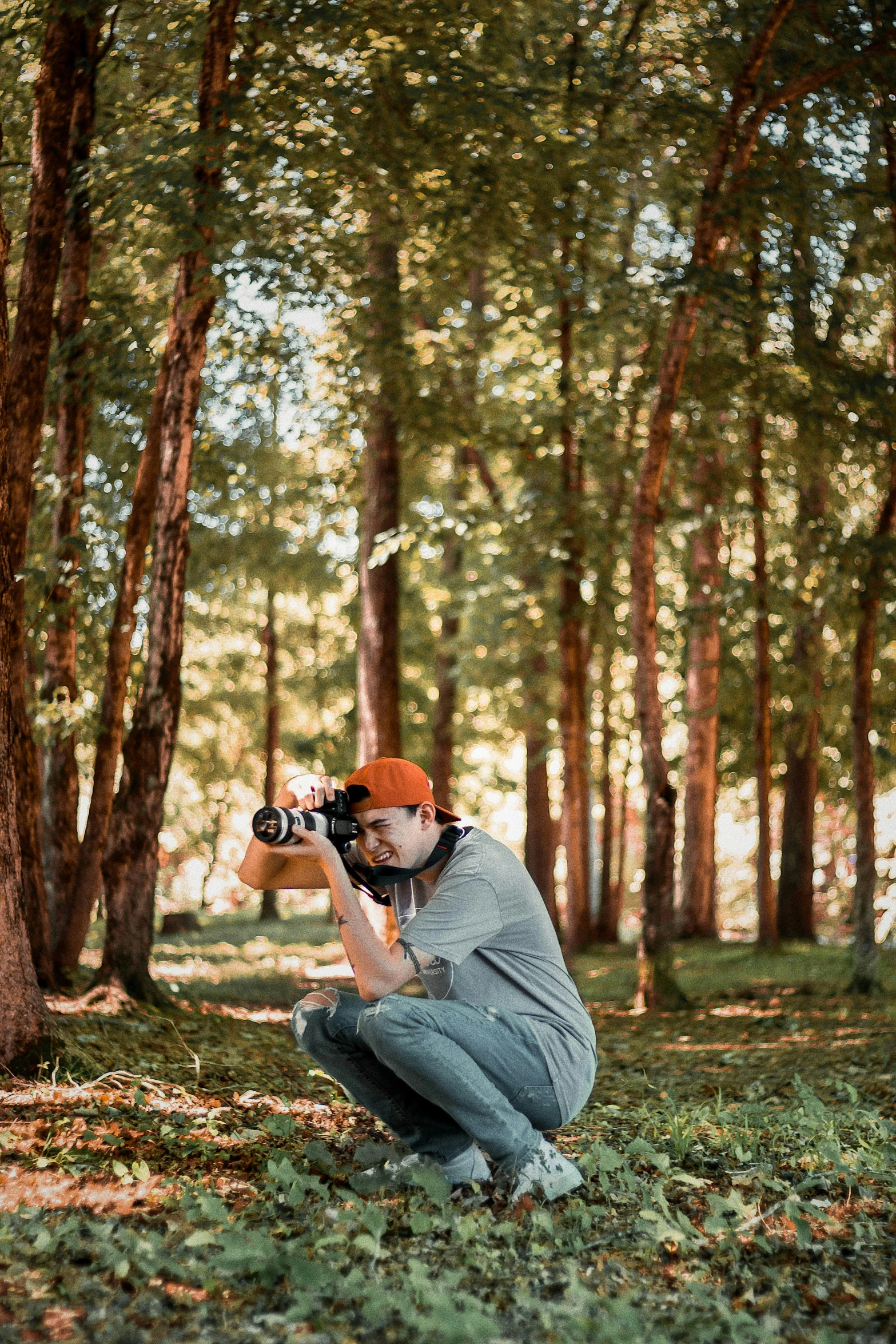 a person squatting down while taking a po with a camera