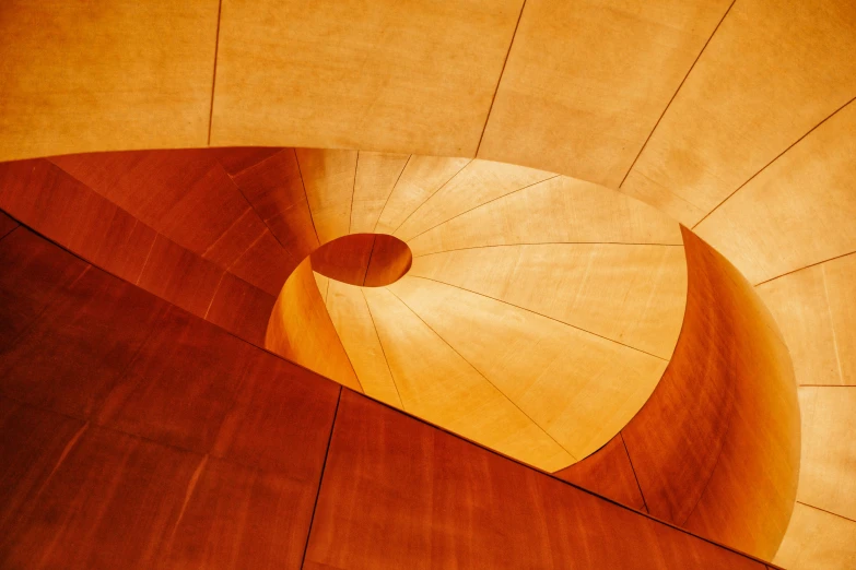 a large spiral staircase with wooden floors