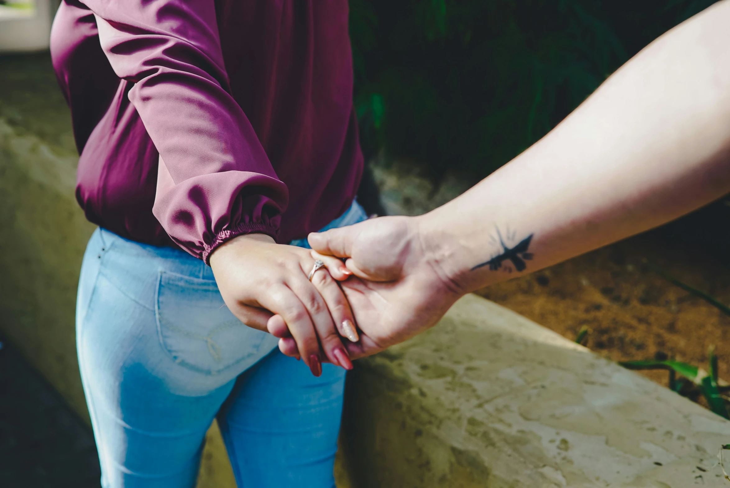 a young man and woman are holding hands