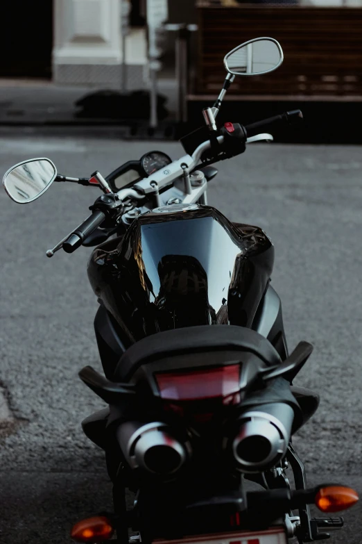 a black motorcycle parked on the side of a road