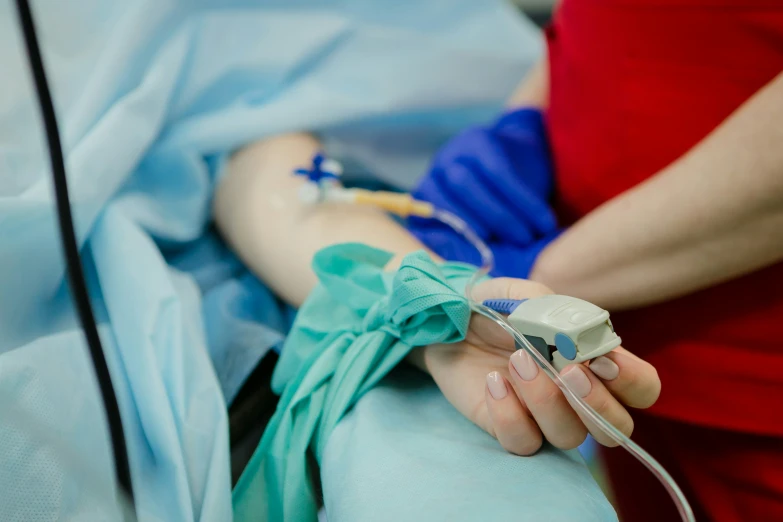 a nurse holding an iv pump in the hospital