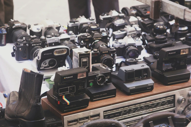 a bunch of cameras and their cases on a table