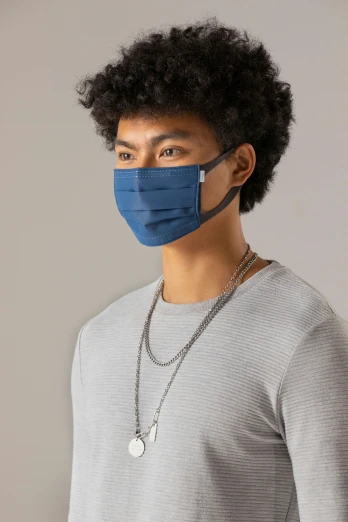 a person wearing a blue face mask with a long string