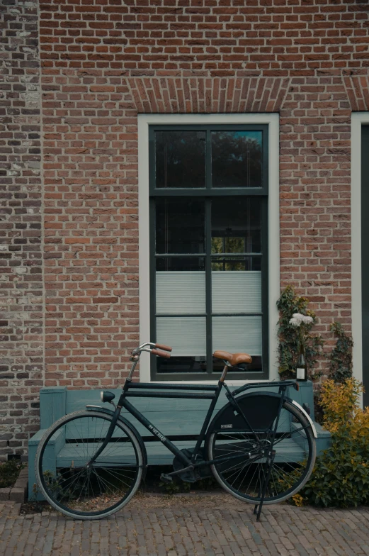a bicycle is parked near a bench in front of a house