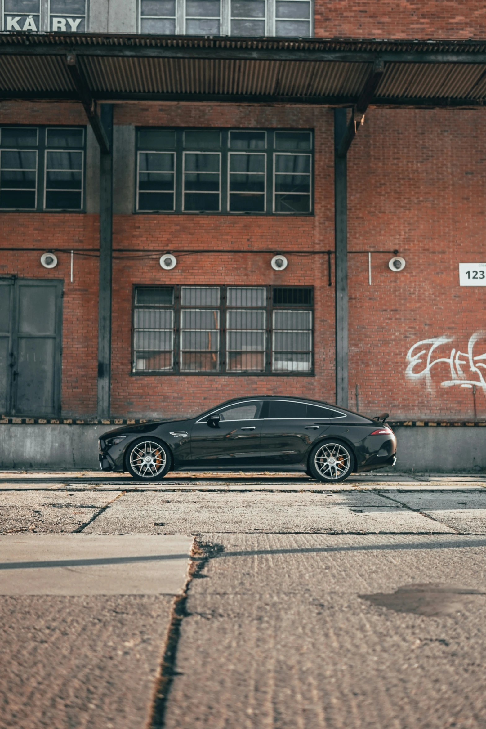 there is a car parked next to a building