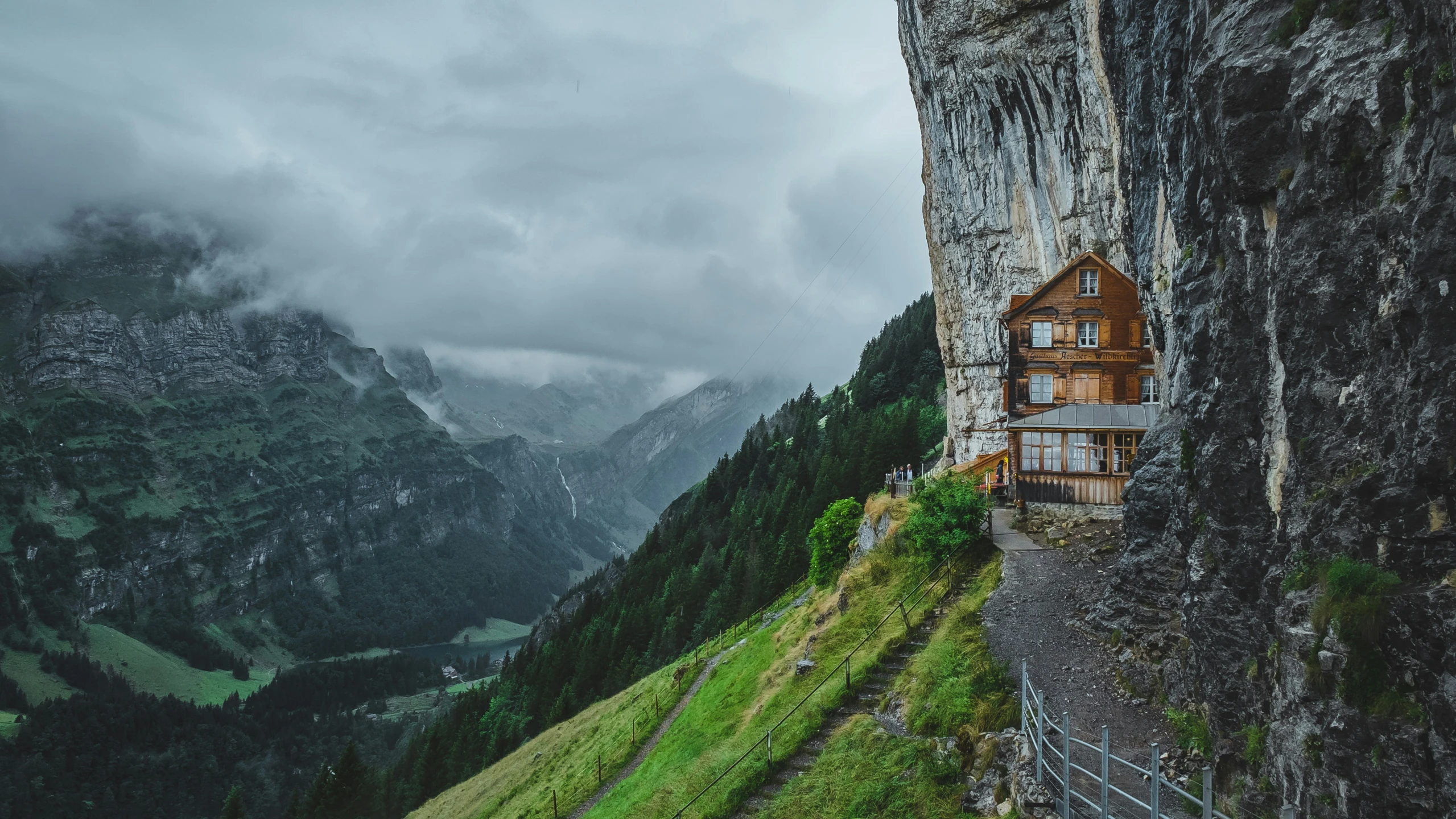 a large cliff house that is on the side of a mountain