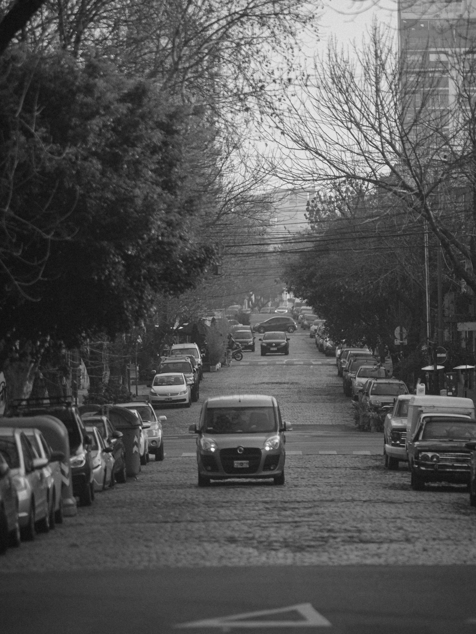 an empty city street that has cars on it