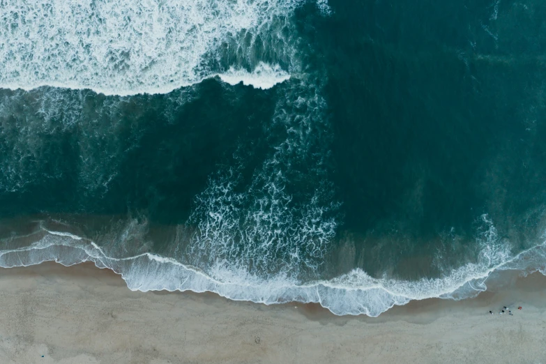 an aerial view of waves in the ocean