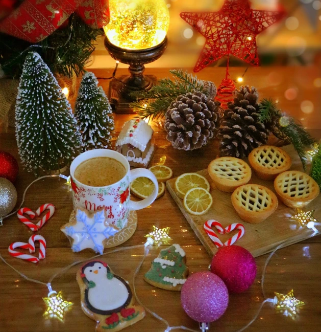 the table has cookies, lemon slices, and christmas decorations