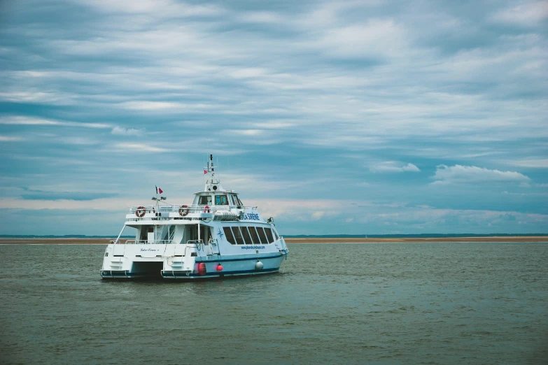 the big blue and white ferry boat in the ocean