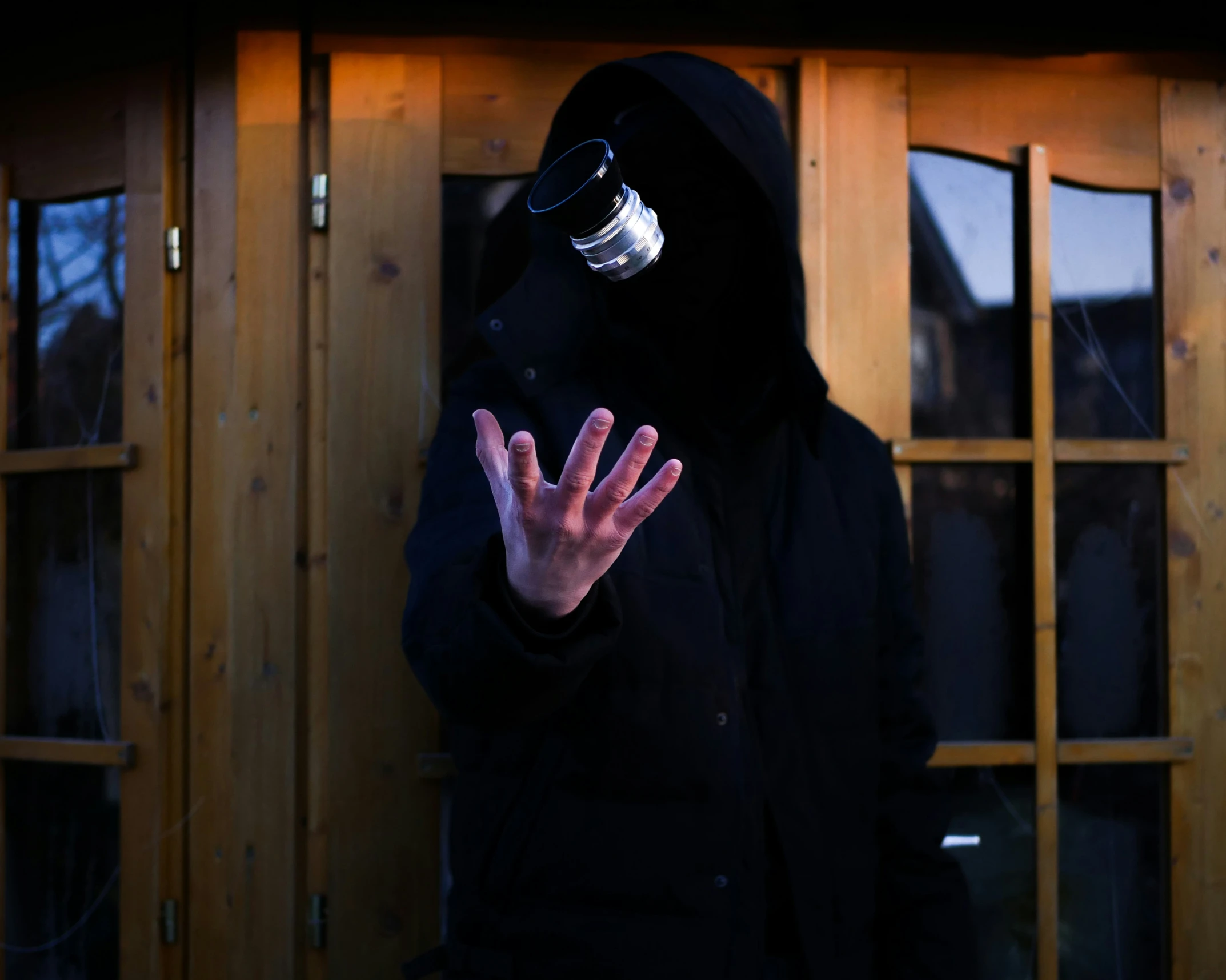 a man wearing a mask and a black jacket