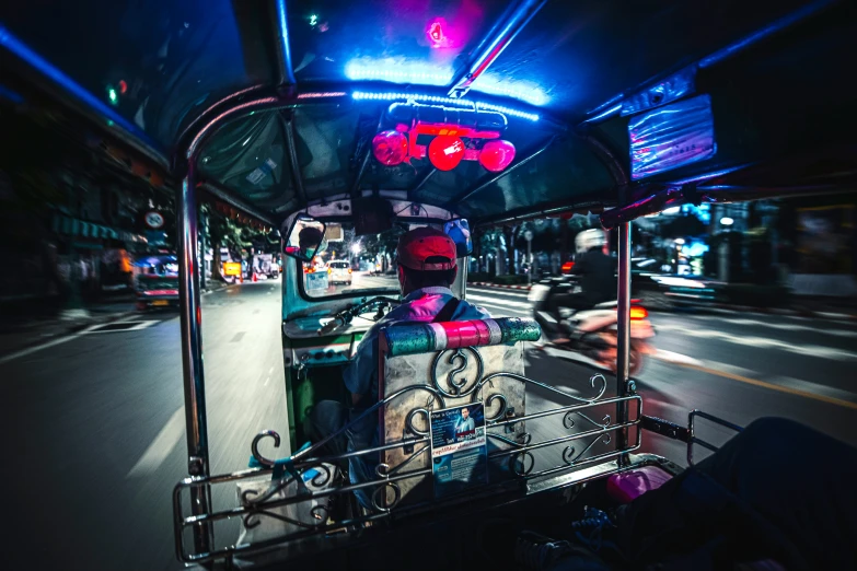 a man riding a bike down a city street