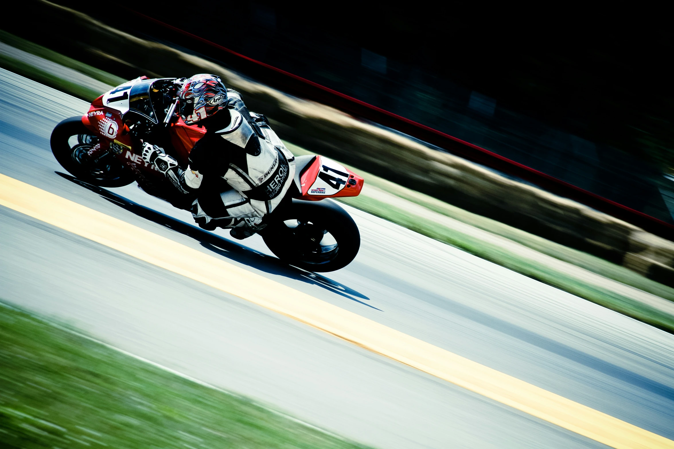 a motorcycle racer speeds fast along the track