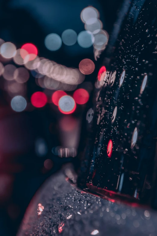 closeup of an automobile dashboard with many lights in the background