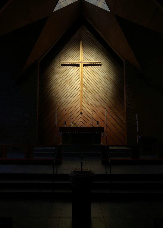 a lit cross on the wall of a church